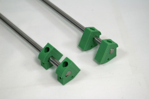 Push two printed motor brackets onto the end of each smooth rod. Note the orientation, and that the bracket closest to the end of the rod should be flush with the end.