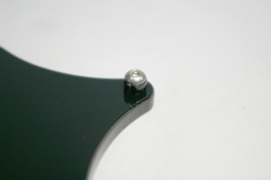 Screw an M3x8mm button head screw through the bed spacer